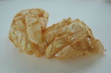 grapefruit sculpture hands peels sown together fragile